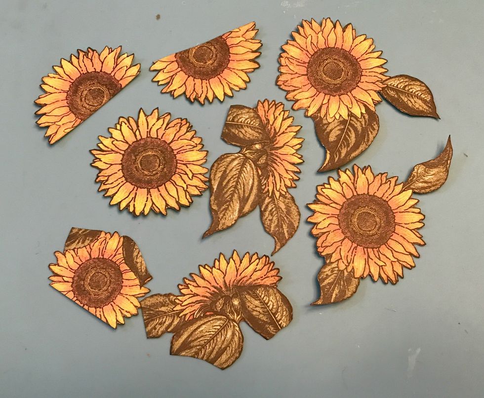 From the sunflower paper, fussy cut seven sunflowers out. Ink the edges of the sunflowers using Black Soot Ink and a Blending Tool with foam.