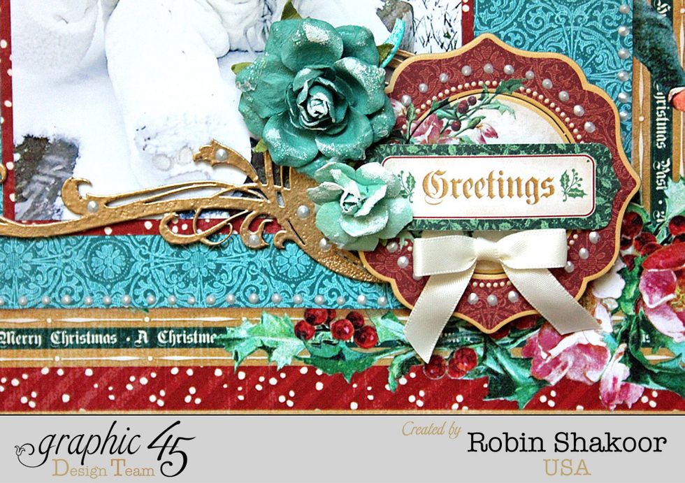 From the Tags and Tickets sheet, add the "Greeting" tag to the center of the chipboard circle.  Add two flowers to the upper left side of the round chipboard shape as shown. Add a bow below the tag.