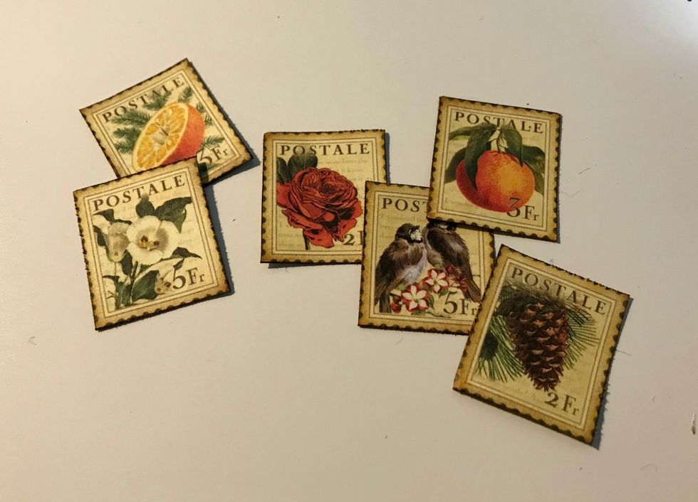 From the Winter Collective paper, fussy cut six stamps out. Distress the edges. Ink the edges of the stamps with Dark Cashmere Ink.
