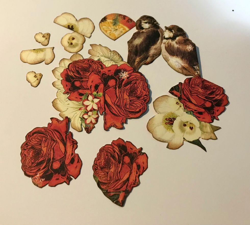 From the Winter Paper, fussy cut 2 birds, 5 white flowers, 1 orange, 2 red roses, 2 red roses/white flower bunches. Ink the edges of the fussy cut images using Dark Cashmere Ink.