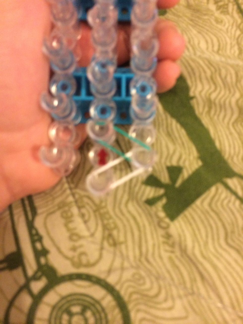 From where you left off, place a band on the pin diagonally above it.