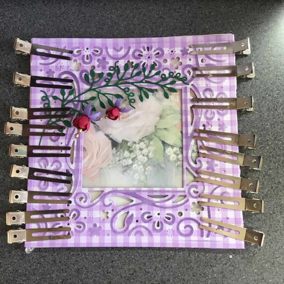 Front of card, clips holding backing card in place whilst glue dries.