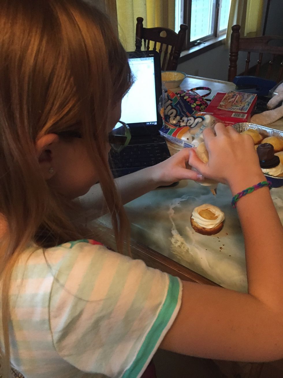 Frost cupcakes - we used our Pampered Chef decorating frosting containers to puff up frosting.