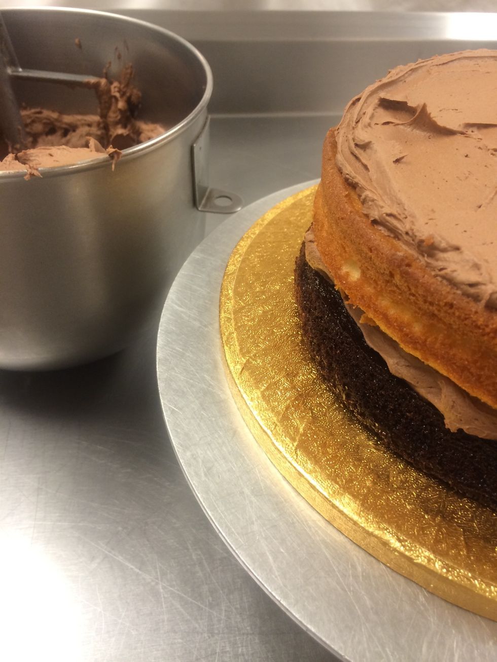 Frosting on the second layer of cake.