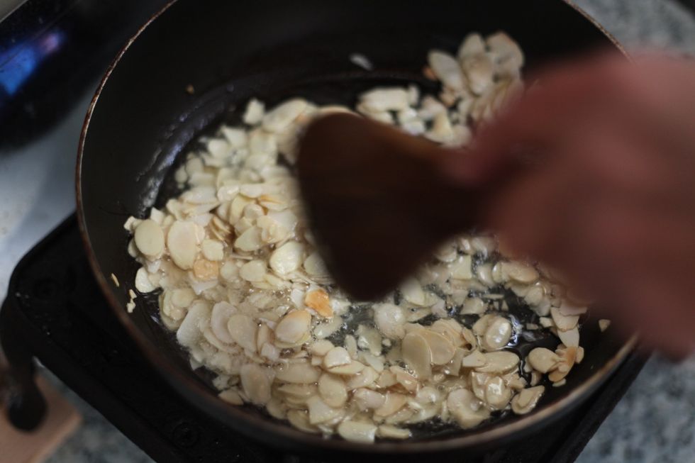 Fry 3/4 cup of sliced almonds. It's up to you if you wish to add more or remove the almonds all together. This dish is traditionally done with pine nuts. But Not anymore. We break all the rules. Lol.
