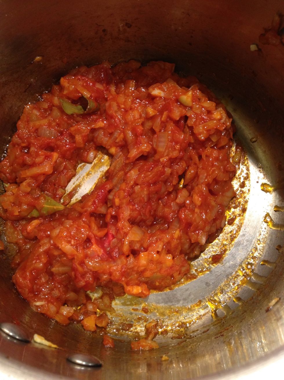 Fry it for a couple of minutes. If using fresh tomatoes make sure you let it reduce until its fully dried.