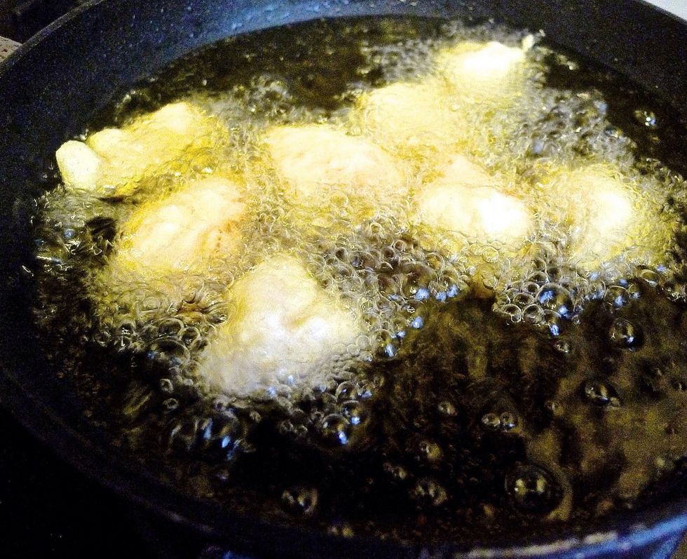 Fry the batter coated chicken in the oil for about 10 minutes or until they are golden brown and cooked through.