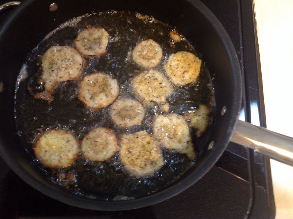 Fry the breaded eggplant slices in oil until browned on each side (turn once). I fry the breaded eggplant slices in batches so that they don't stick to each other. You can opt to bake vs. fry.