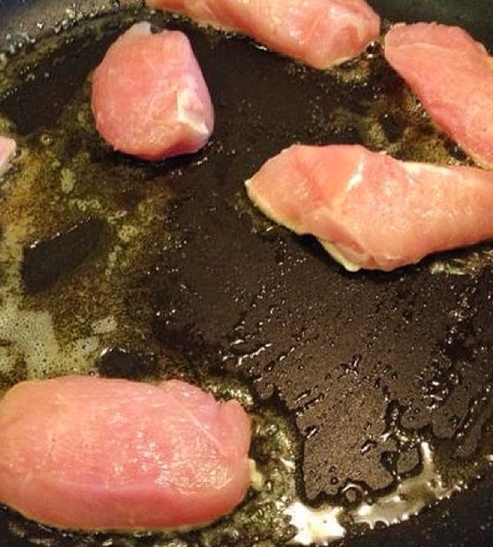 Fry the chicken. It doesn't need to get cooked all through since it will later boil in the sauce.