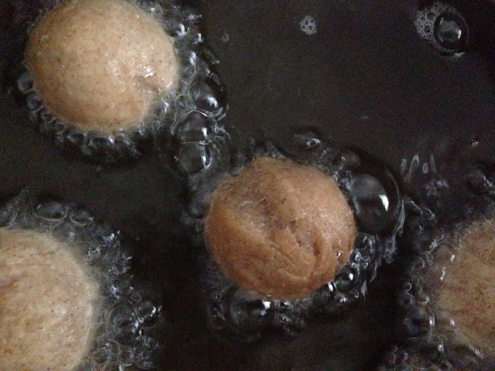 Fry the donuts in 3 cups of oil for 5-7 minutes. They will become golden brown and very tasty. As the chef, you deserve to sample a few :)