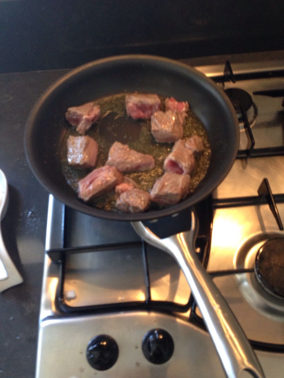 Fry the meat in olive oil lightly. A few cubes at a time, don't over crowd the pan. Set aside when done.