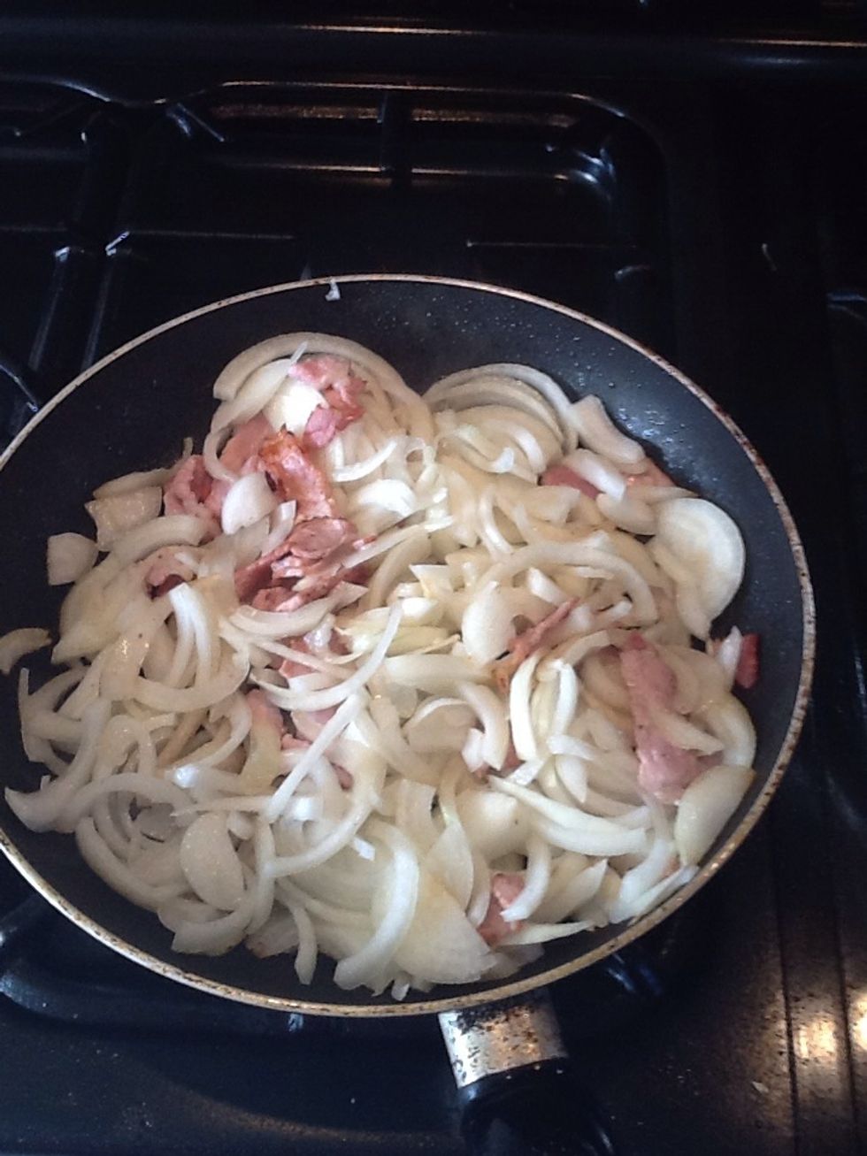 Fry the onions and bacon until the onions are soft