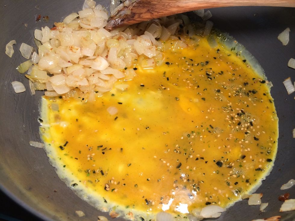 Fry the onions until soft. Add seasoned egg. Fry until cooked. Break into small pieces.