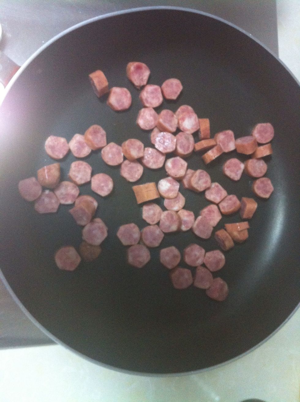 Fry the sausages, to add some color.
