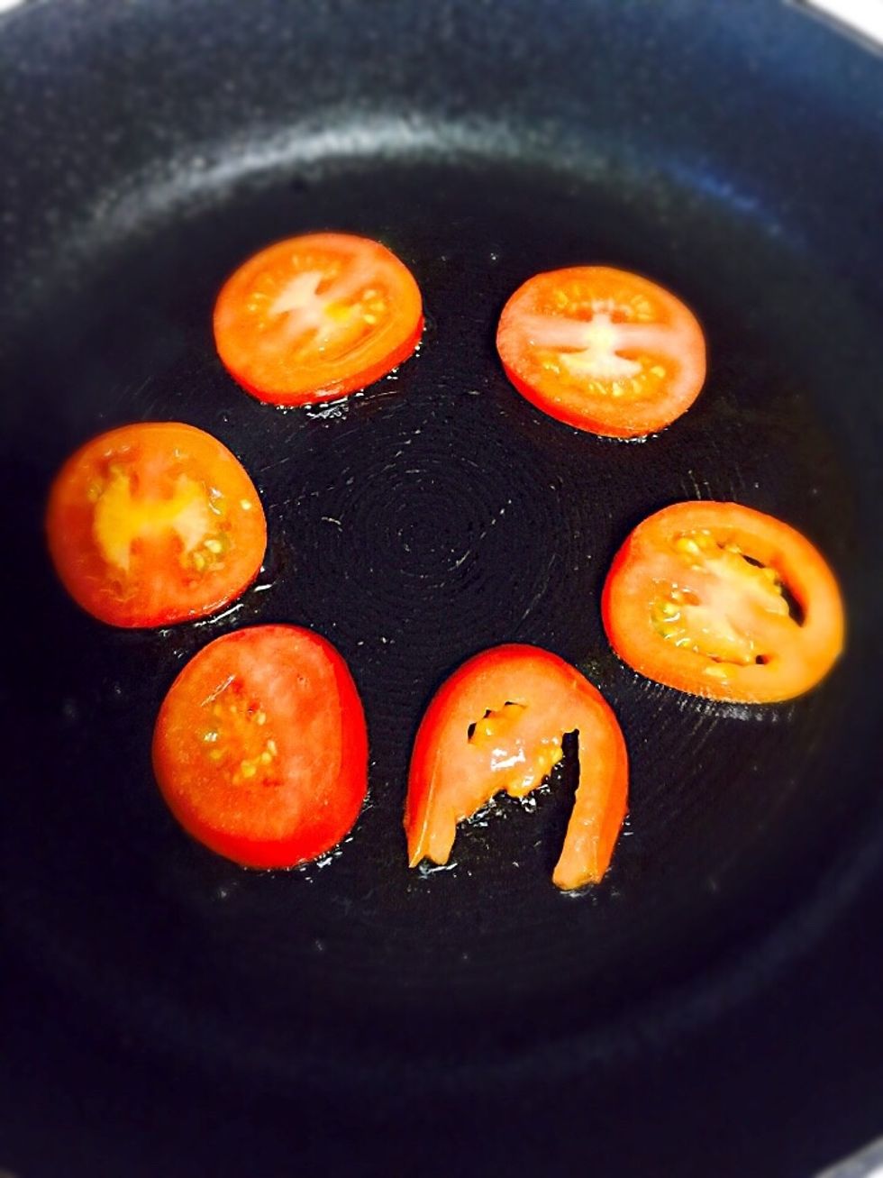 Fry the tomato slices in olive oil, and when turning the slices over brake the eggs