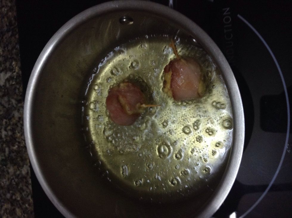 Fry them on low heat, when you see the meat is kinda golden, put the lid on the pan you're frying with for about 30 seconds, doing that helps the cheese inside melt without burning the outside.