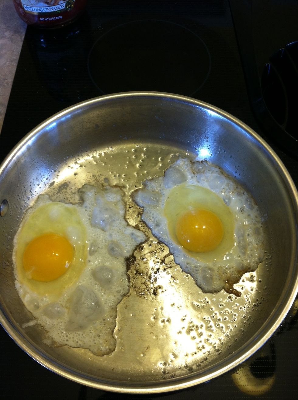 Fry two eggs in coconut oil - any style.