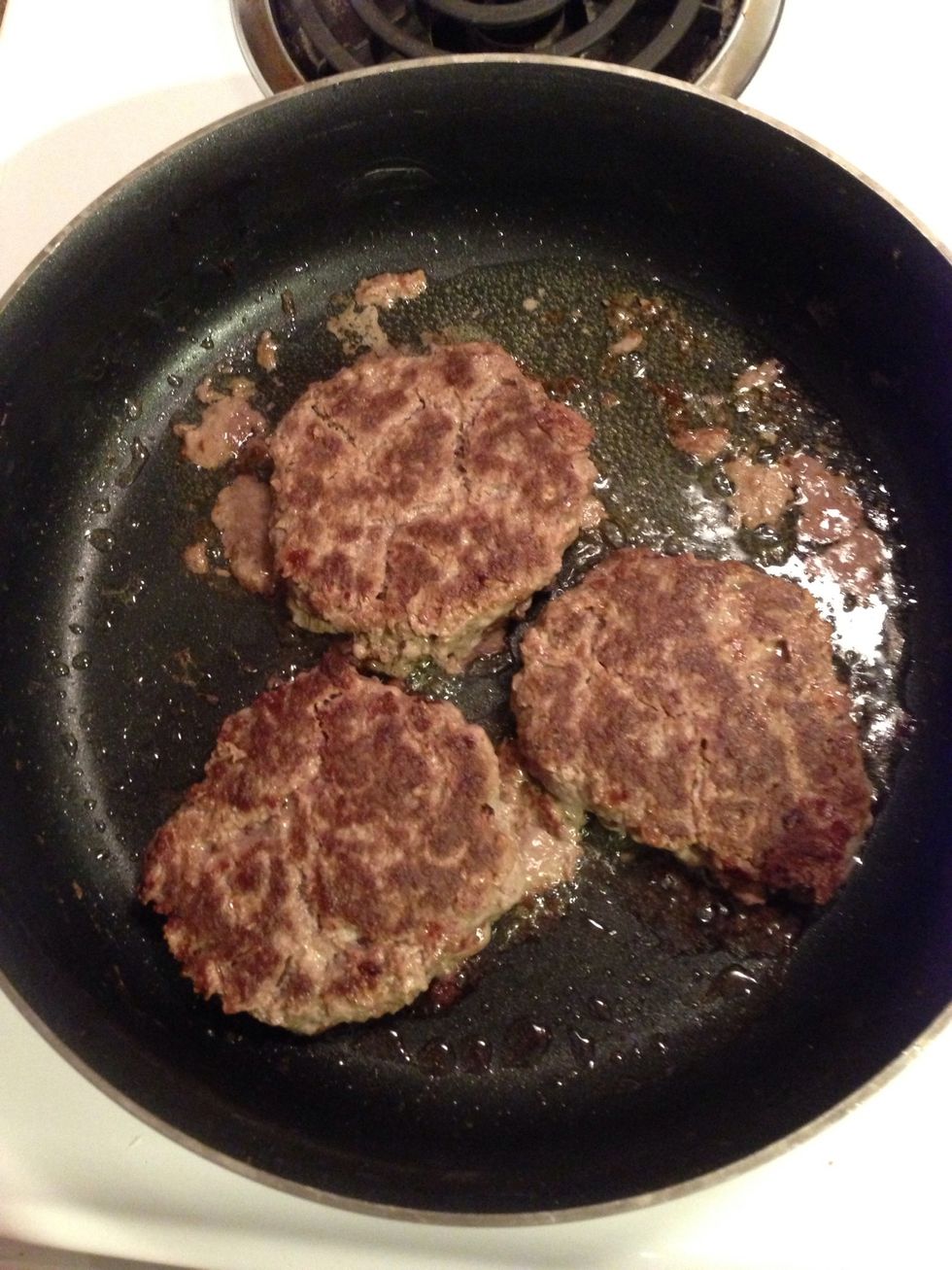 Fry your patties... Mix your hamburger, an egg and your choice of seasoning. I used garlic and onion powder, season salt and pepper... Roll them into patties and into the frying pan.