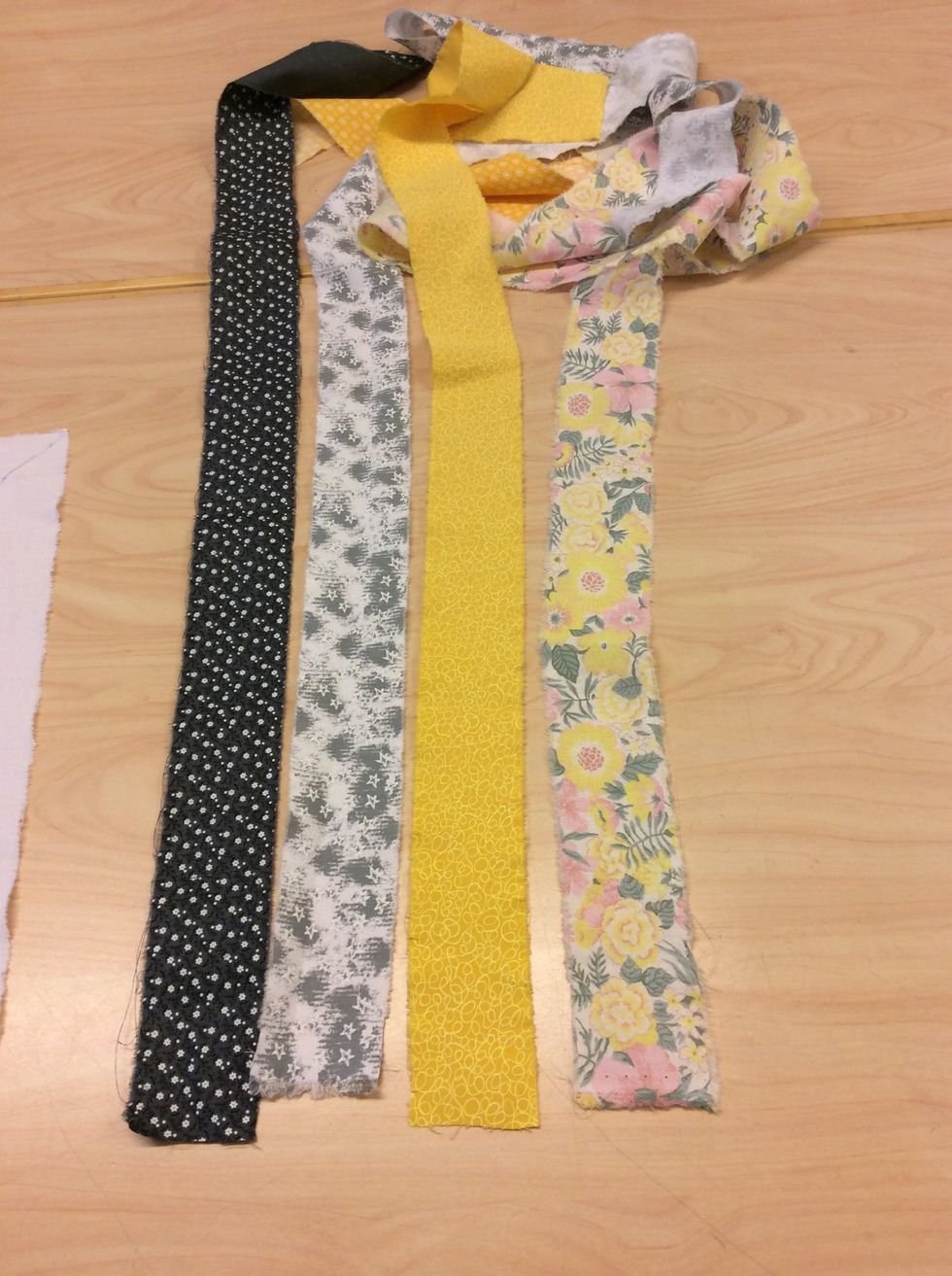 Fundera ut vilka tyger du vill ha, se till att du tycker de matchar och passar med varandra. Riv tygerna 6 cm breda genom att f\u00f6rst klippa ett jack i tyget och sedan dra med b\u00e5da h\u00e4nderna.