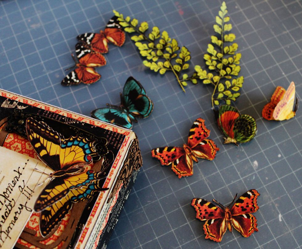 Fussy cut butterflies and leaves from pattern paper. Layer like butterflies together at the body and bend wings up.