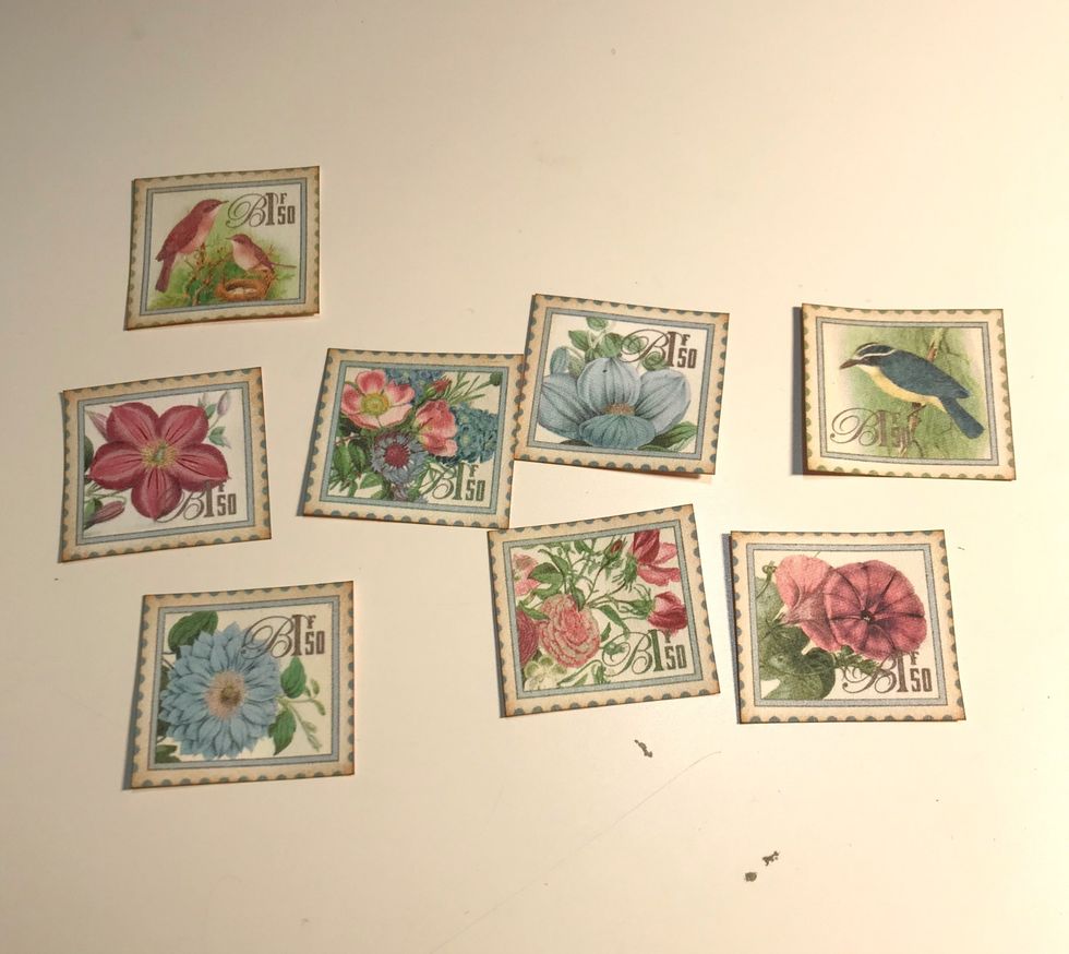 Fussy cut eight stamps from the paper. Ink the edges of the stamps using Vintage Photo Distress Ink.