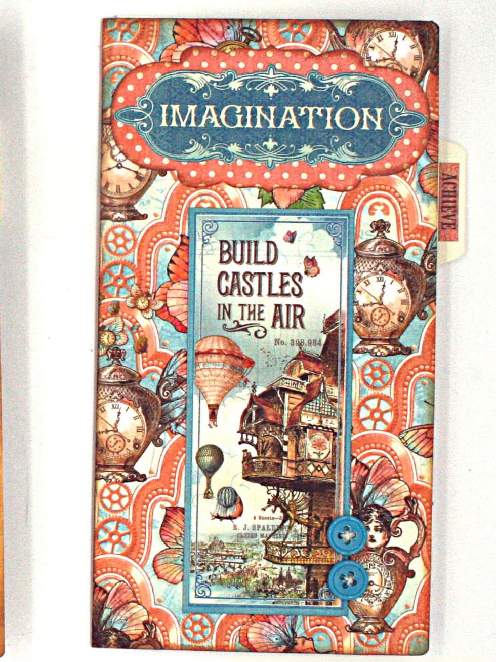 Fussy cut Imagination word from Up & Away, mat on B side of Castles in the Air & adhere at the top.   Trim the  cut-apart shown from Castles in the Air & adhere along with 2 buttons as pictured.