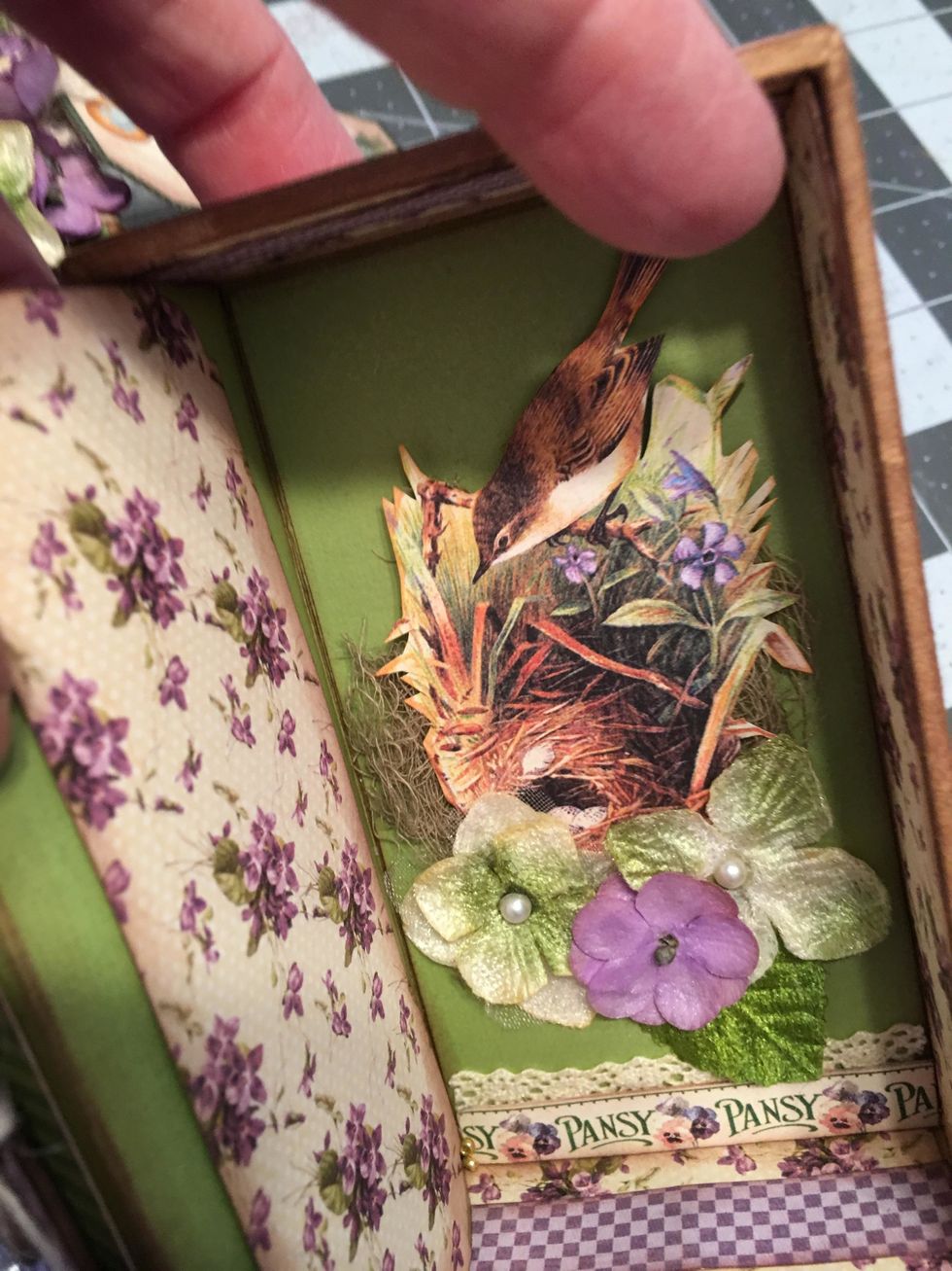 Fussy cut out some elements such as the bird and nest and glue into place with some of the flowers.