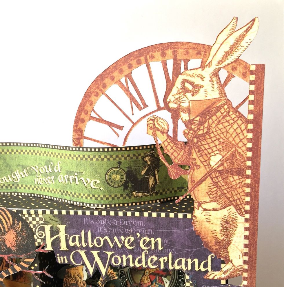 Fussy cut rabbit and clock figure and glue on the upper left side.