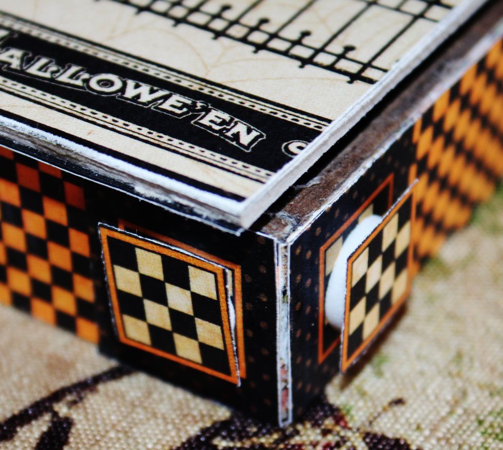 Fussy cut small squares from pattern paper; add to front of sides of box stand with pop dots.