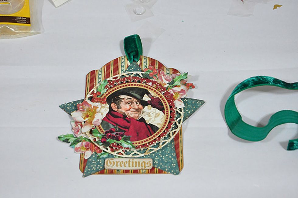 Fussy cut some flowers and leaves and adhere to the tag. Add a green velvet for the finishing touch