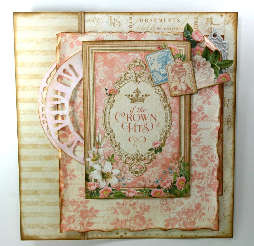 Fussy cut stamps from G45 Her Majesty. Ink all sides well and attach to top right corner.