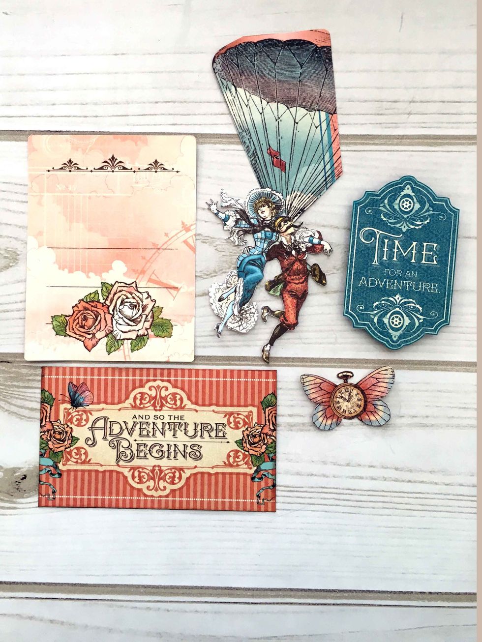 Fussy cut the balloon from a large ephemera card.  Locate a small ephemera card to use.  Find the other elements on the design papers:  Up and Away, Adventure Beckons, & Spread Your Wings.