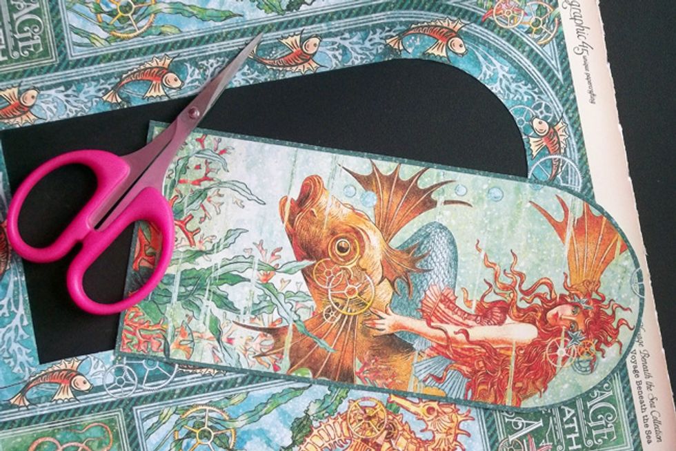 Fussy Cut the Mermaid Image from the Title Page of the Graphic 45 Voyage Beneath the Sea 8x8 paper, as shown