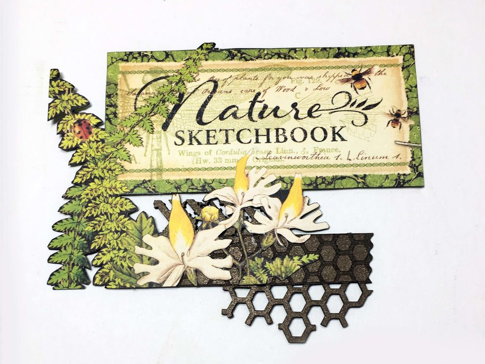 Fussy cut the title & foliage as shown from  Nature Sketchbook. I'm using a piece of chipboard (Creative Embellishments WashiTape Clusters) so that the fussy cut pieces have something to support them.