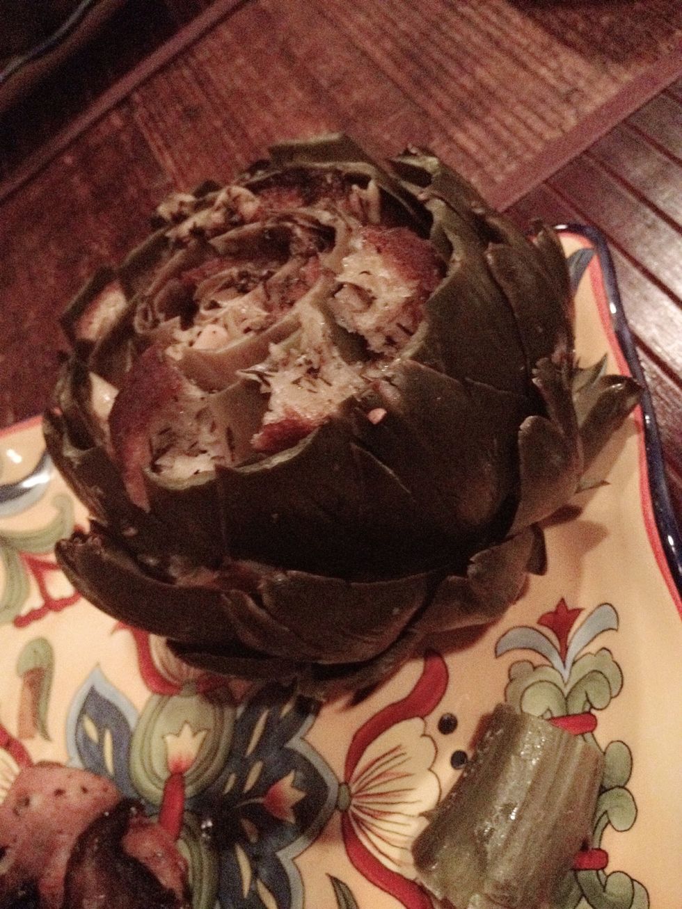 Garlic bread stuffed artichokes ready to be eaten! You can add some mayonnaise with the leaves for taste.