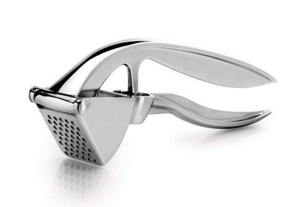 Garlic Press. Used to squish garlic. I can use a garlic press to make garlic bread.