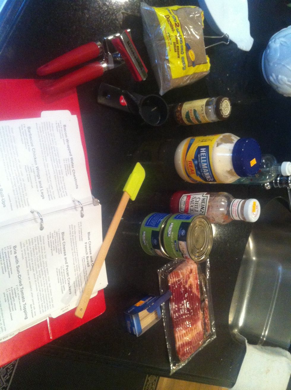 Gather all of your ingredients: bacon, toothpicks, spatula, water chestnuts, mayo, chili sauce, crushed red peppers, dark brown sugar.
