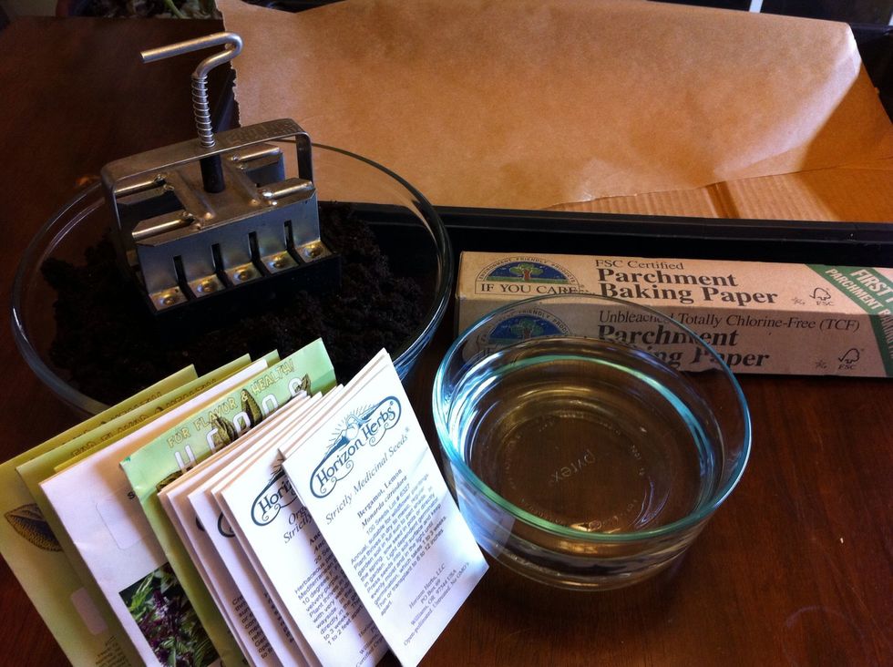 Gather all supplies. We also put cardboard under parchment paper in seed tray base. Cardboard adds structural stability for soil cubes; parchment keeps seedling roots from attaching to cardboard.