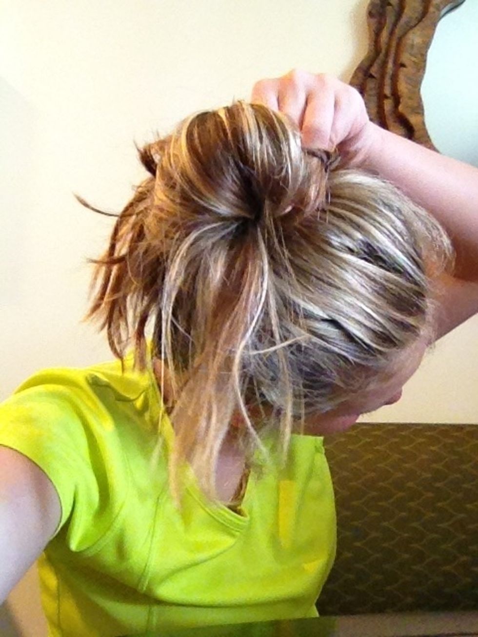 Gather all the excess hair. Wrap it around the bun.