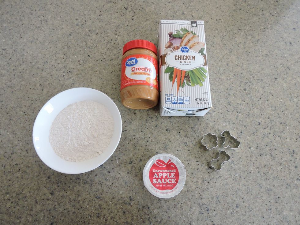 Gather all the ingredients (flour, peanut butter, apple sauce, chicken broth, cookie cutters).