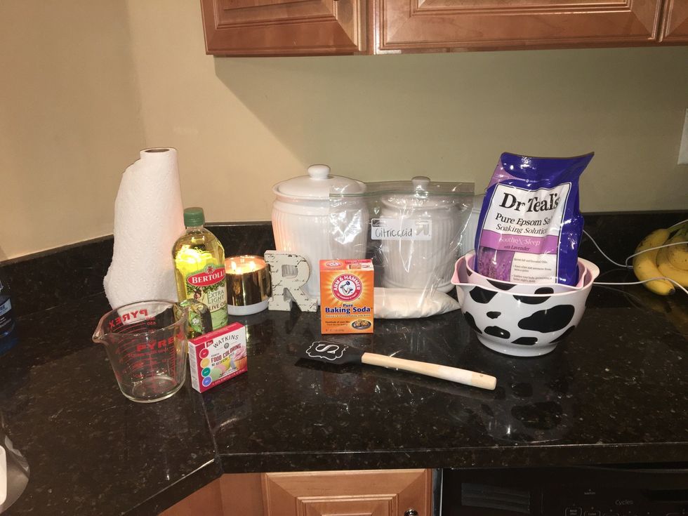 Gather all the needed ingredients; Baking soda, Epsom salts, Citric acid, Olive oil, Food coloring, Water, Two bowls, Measuring Cup, and something to mix with.