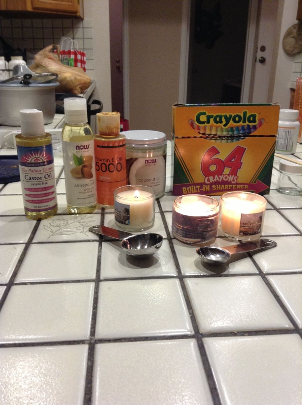 Gather all your ingredients : castor oil,almond oil, vitamin e oil, coconut oil, crayons, candle, teaspoon and tablespoon, Popsicle stick, container