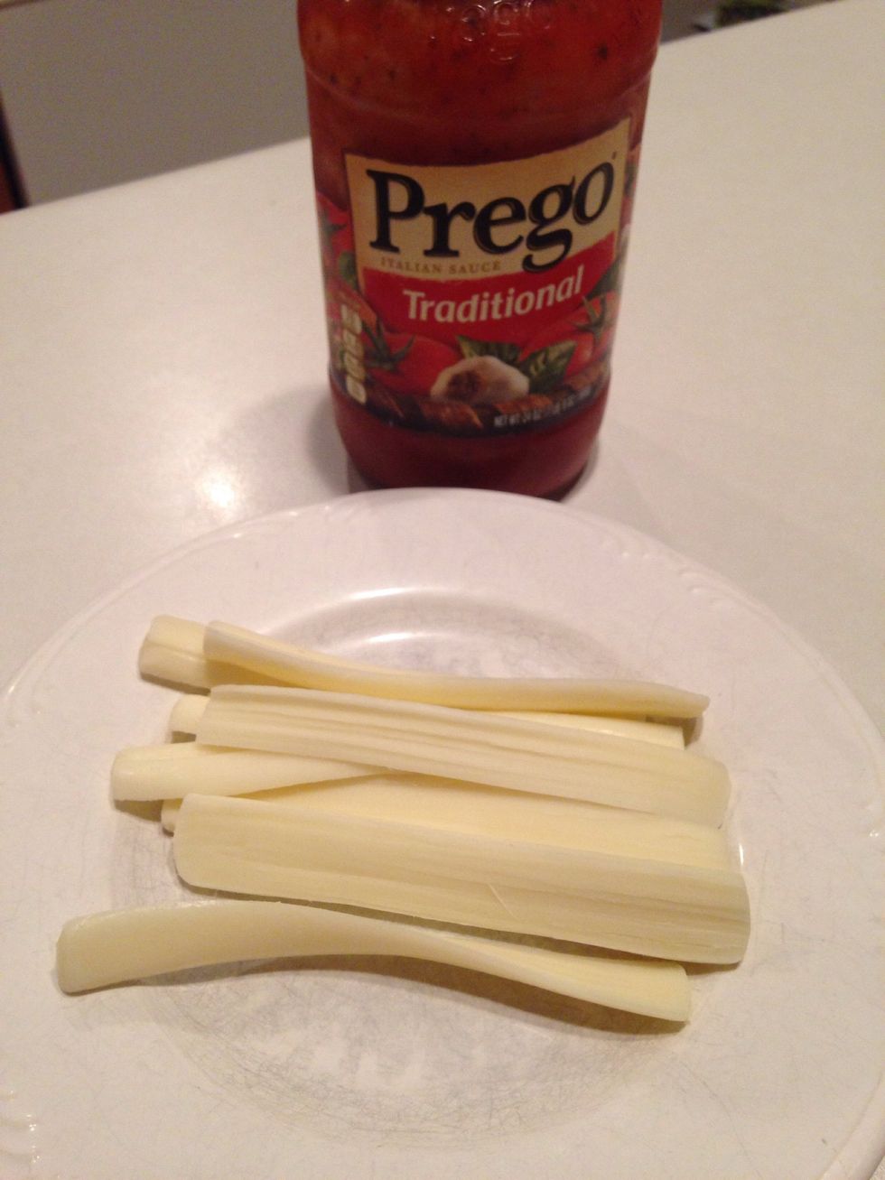 Gather cheese and spaghetti sauce. I didn't have any mozzarella slices, so I just sliced cheese sticks.