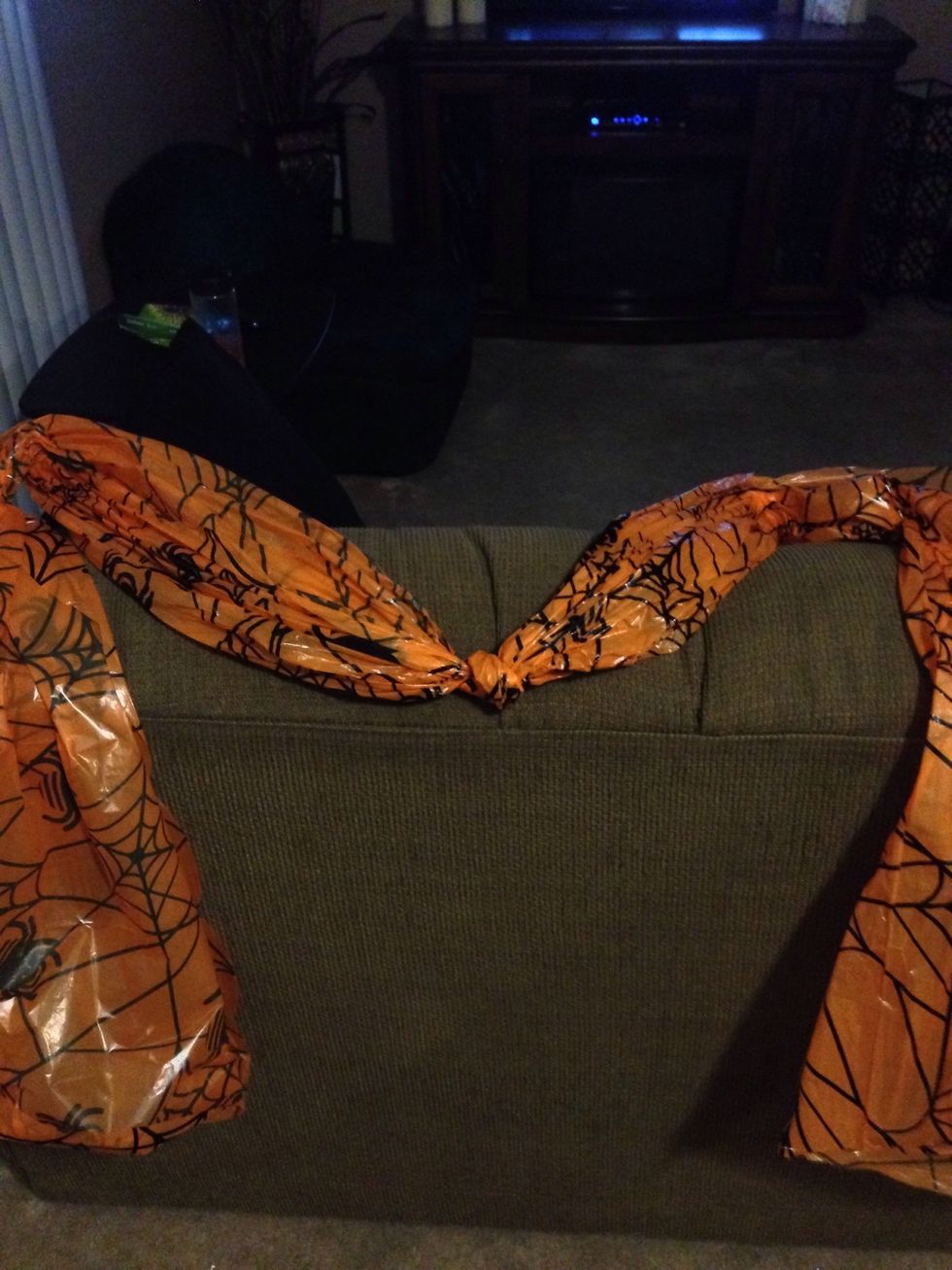 Gather either side of tablecloth and make two more knots