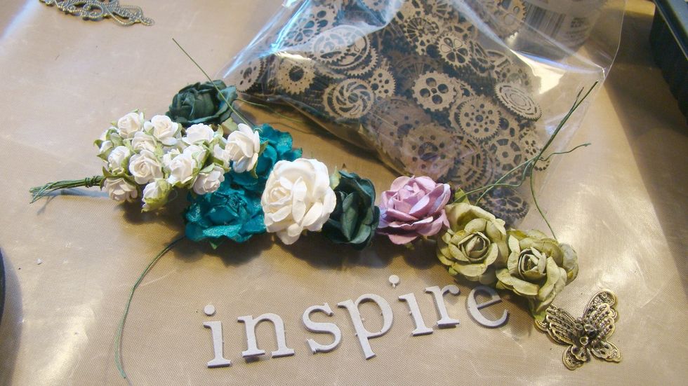 Gather embellies you want to adhere to your project. I used chipboard, metal, grungeboard letters & mulberry flowers.