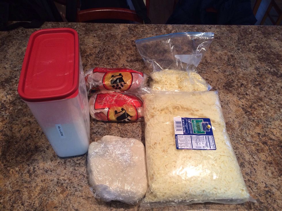 Gather ingredients. Most pizza restaurants will sell you a "dough ball" mine does for $2.50/ea. or you can try store brand, or home made.Pre-heat your oven 350-375 depending on how evenly it cooks.