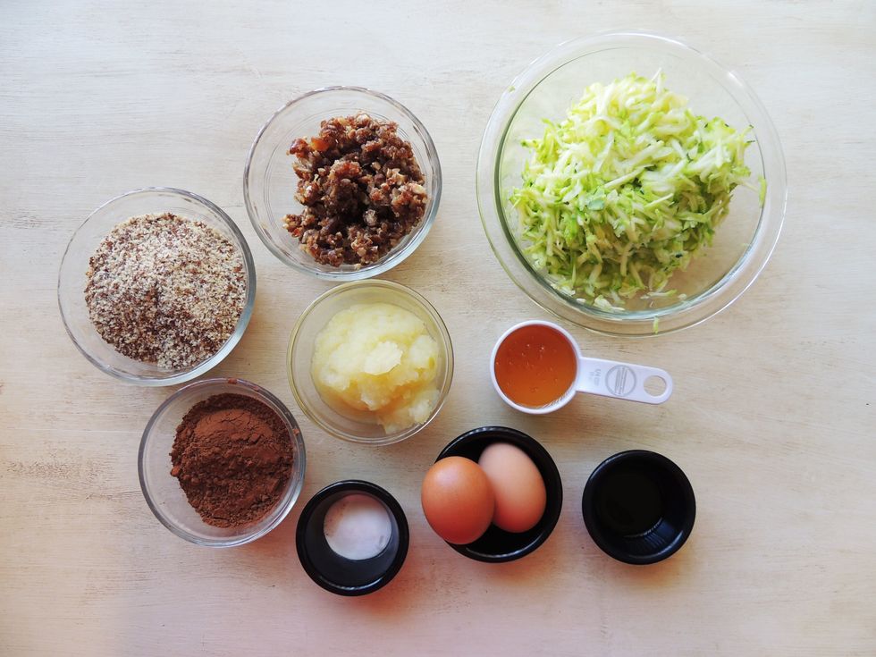 Gather ingredients.  You can substitute whole wheat flour for a much drier cake.  Grate the zucchini, chop the dates, make your own applesauce from 1 granny smith apple (peeled, boiled and blended).