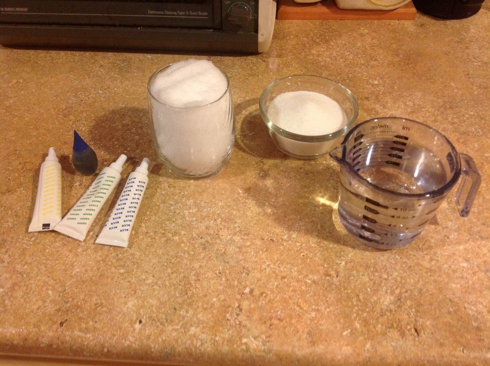 Gather one part sugar, two parts water, the color of food coloring that you want your ice to be, and a glass full of fresh (white) snow. Stick the snow in the refrigerator.