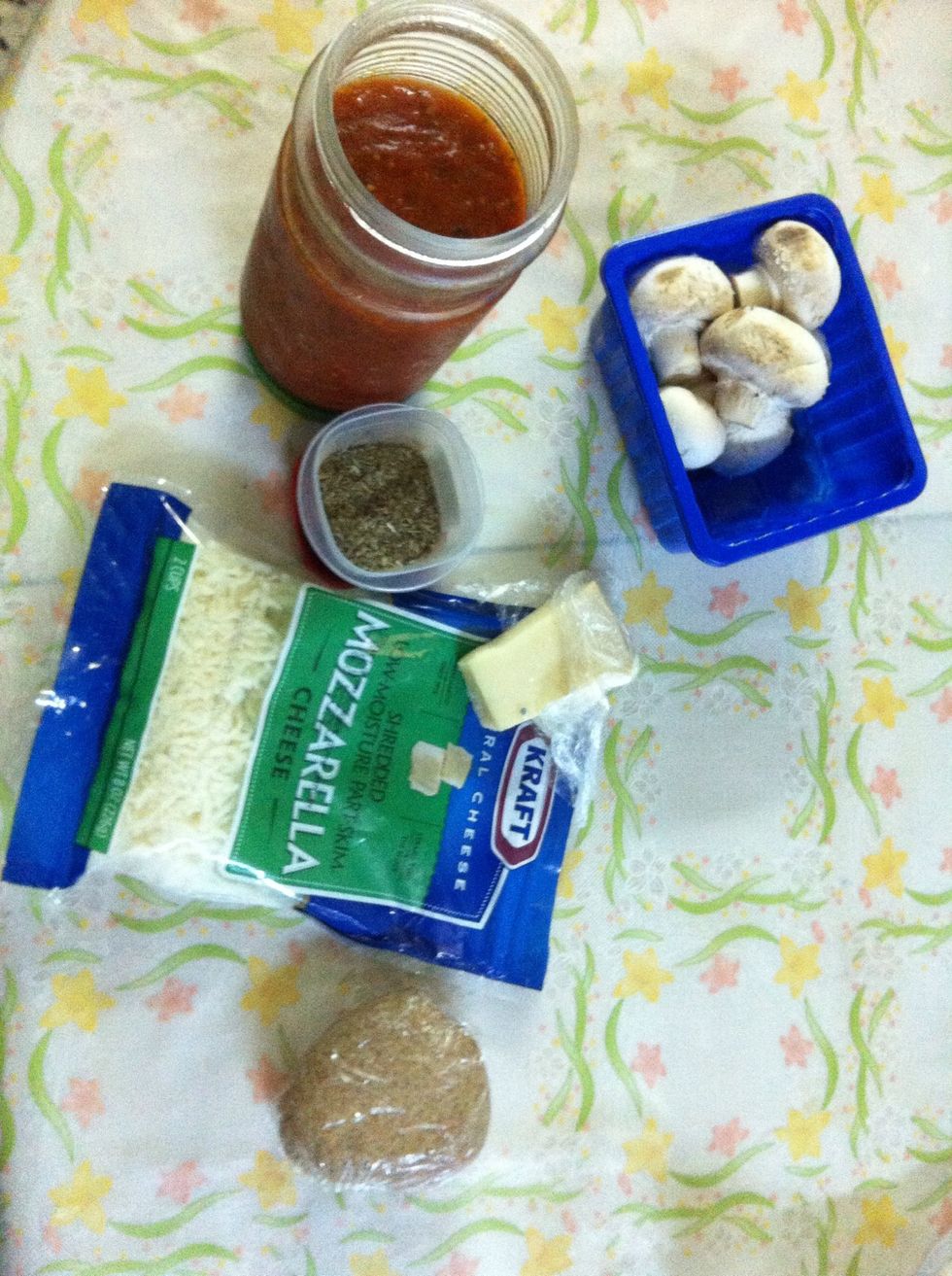 Gather out your ingredients, I'm keeping it healthy with the whole wheat crust and part skim cheese.