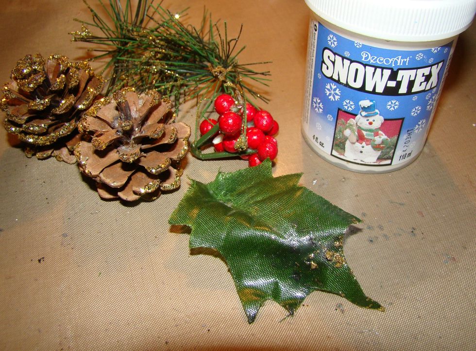 Gather some winter floral pics, pine cones, berries etc. Dab a bit of glitter on them. Apply Snow Tex to the edges of your floral items. Allow to dry.